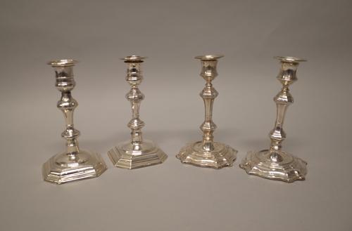 A pair of silver table candlesticks, each with a knopped stem, raised on a cut cornered square base, the hallmarks rubbed, height 18.5cm and a pair of