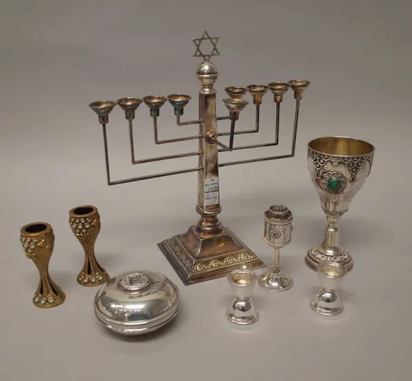 A group of Judaica, comprising; a Chanukiah nine light candlestick, with a Star of David finial, raised on a decorated square base, London 1948, a cir