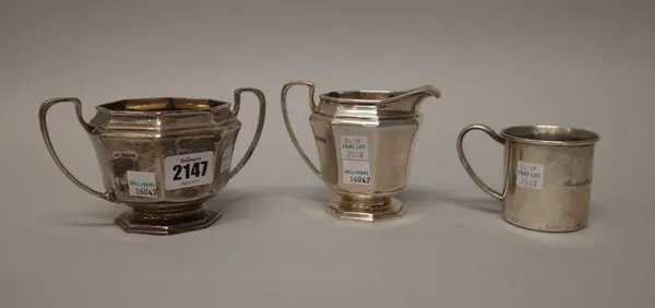 A silver twin handled sugar bowl, of octagonal form, with a milk jug in a matching design, both Sheffield 1928 and an American christening mug, engrav