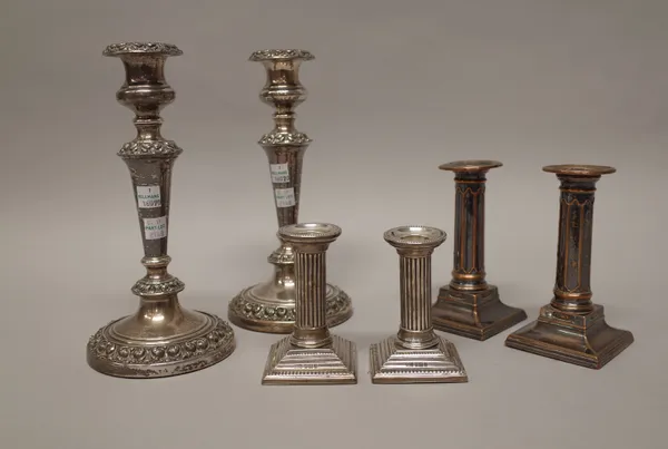 A pair of silver candlesticks, each formed as a Corinthian column, raised on a stepped square base, decorated with beaded rims, Birmingham 1901, heigh