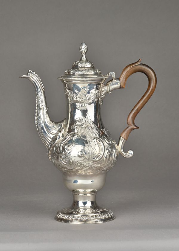 An early George III silver coffee pot, of baluster form, with later embossed decoration depicting floral and rustic views, within Rococo scrolling bor