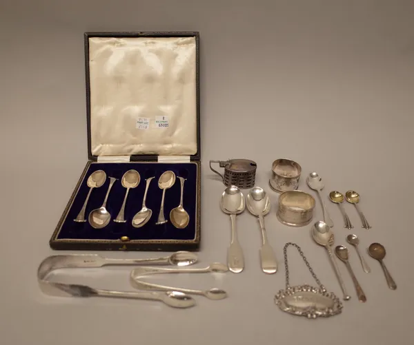 Silver, comprising; six similar teaspoons, with an associated case, two pairs of sugar tongs, two napkin rings, an oval mustard pot, with a blue glass