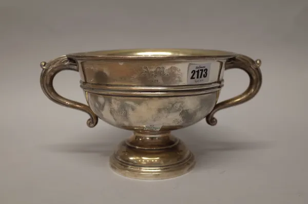 A silver twin handled trophy bowl, with scrolled handles, raised on a circular foot, engraved A.M 1921, diameter 21cm, Sheffield 1921, weight 737 gms.