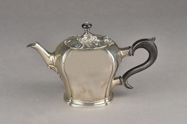 An 18th century and later Dutch silver batchelor's teapot, the hinged lid decorated in the Rococo taste, fitted with a later ebony handle, the undersi