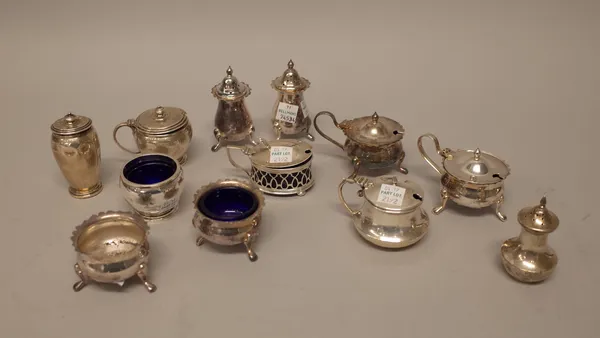 Silver, comprising; a five piece condiment set, three mustard pots, two pepperettes and a salt, combined weight 521 gms and another salt, maker's mark