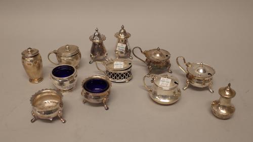 Silver, comprising; a five piece condiment set, three mustard pots, two pepperettes and a salt, combined weight 521 gms and another salt, maker's mark