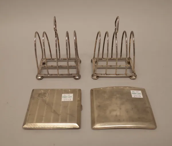 Silver, comprising; a pair of five bar toastracks, each of arched Gothic form, with a loop shaped handle and raised on four bun feet, Birmingham 1920