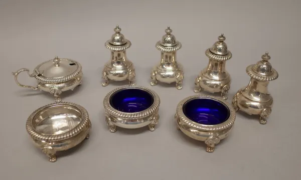 Silver condiments, comprising; four pepperettes, three salts and a mustard pot, each piece of circular form, decorated with a wide gadrooned rim and r