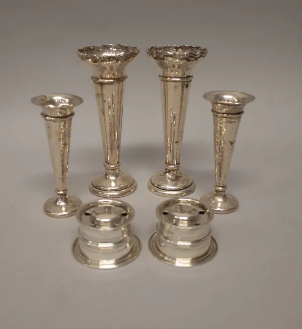 Silver, comprising; a pair of pen and ink stands, each of circular form, London 1899, with one glass liner and two pairs of vases, with loaded bases,