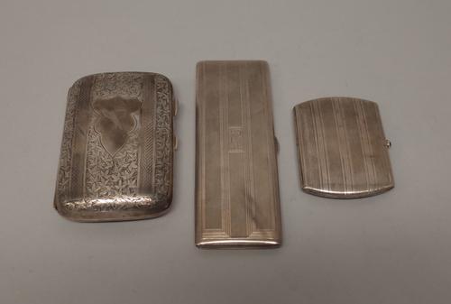 A silver curved rectangular cigar case, with foliate engraved decoration and with engine turned bands at intervals, Birmingham 1902, a silver rectangu