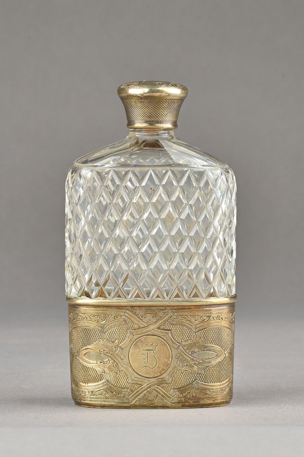 A Victorian silver gilt mounted faceted glass spirit flask, the glass body with cross hatched faceted decoration, the pull-off beaker base with scroll