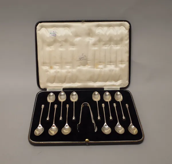 A set of twelve silver teaspoons, with seal top style finials to the handles, Sheffield 1939, with a matching pair of silver sugar tongs, Sheffield 19