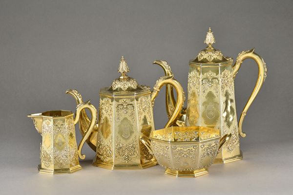 A Victorian silver gilt three piece tea set, comprising; a teapot, a twin handled sugar bowl and a milk jug, each piece of tapered octagonal form, dec