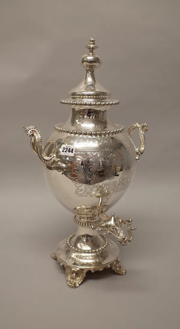 A Victorian silver plated twin handled lidded hot water urn, monogram engraved to the body within a feathered scrolling cartouche, decorated with bold