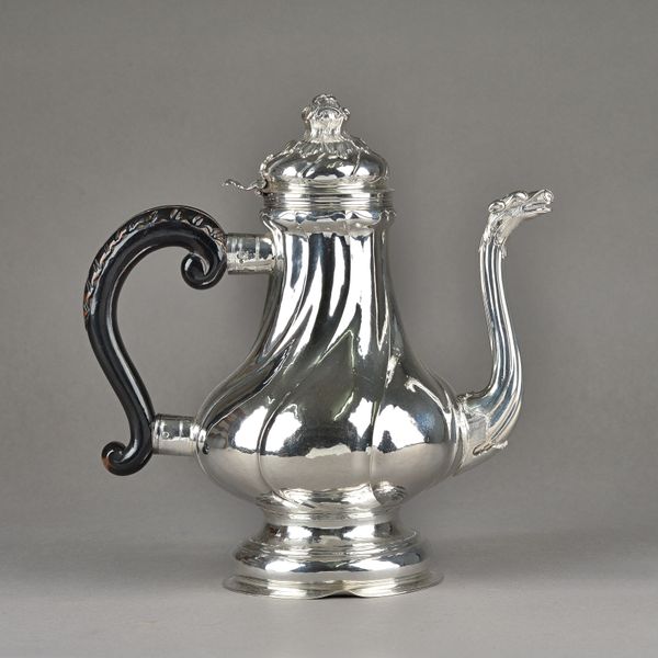 An Italian coffee pot, of pear shaped form, with spiral fluted decoration to the body, the spout with an animal head terminal, the hinged lid with a b