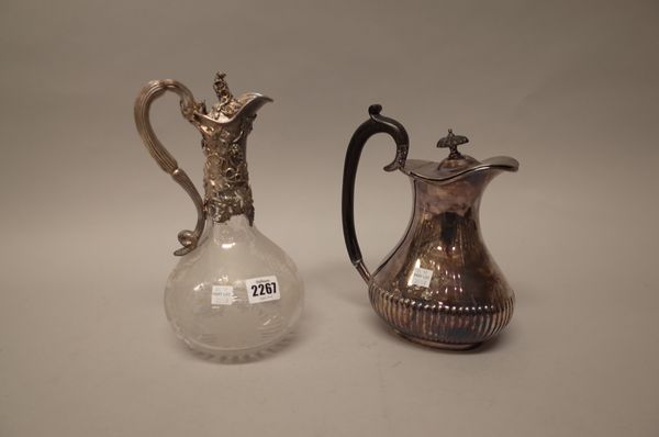 A Victorian silver mounted glass claret jug, the mount and the hinged lid decorated with fruiting vine, the body etched with fruiting vine above a sta