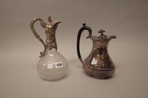 A Victorian silver mounted glass claret jug, the mount and the hinged lid decorated with fruiting vine, the body etched with fruiting vine above a sta