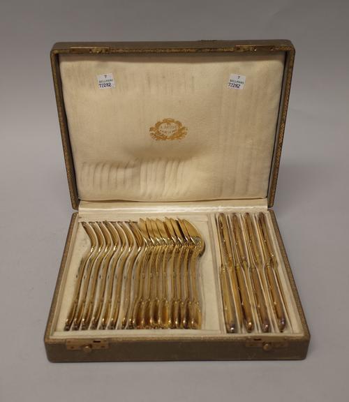 A French silver gilt twenty-four piece dessert service of table flatware, comprising; eight spoons, eight forks and eight knives, each cast and decora