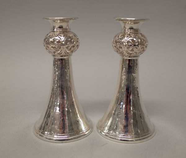 A pair of silver table candlesticks, each of flared trumpet shaped form, with a pierced bulbous stem above a flared circular foot, height 17cm, modern