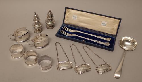 Silver, comprising; a pair of mustard pots, with coloured glass liners, a pair of pepperettes, three napkin rings, three decanter labels detailed Port