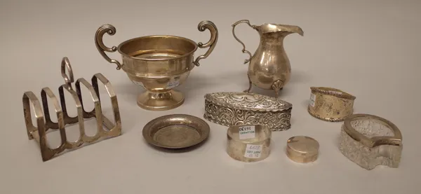 Silver and silver mounted wares, comprising; a circular capstan shaped inkwell, Birmingham 1924, a twin handled trophy cup, Chester 1937, a five bar t
