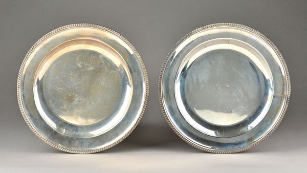 A pair of Victorian silver main course plates, each of circular form, decorated with a beaded gadrooned rim, London 1886, maker John Aldwinckle & Thom