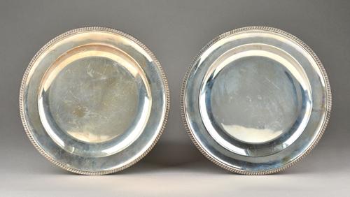 A pair of Victorian silver main course plates, each of circular form, decorated with a beaded gadrooned rim, London 1886, maker John Aldwinckle & Thom