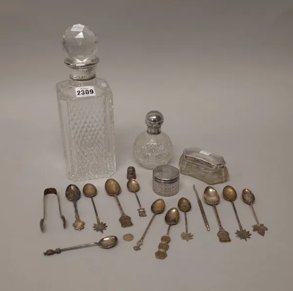 An Asprey London silver mounted faceted glass decanter, London 1973, a silver topped faceted glass scent bottle, London 1919, two silver lidded facete