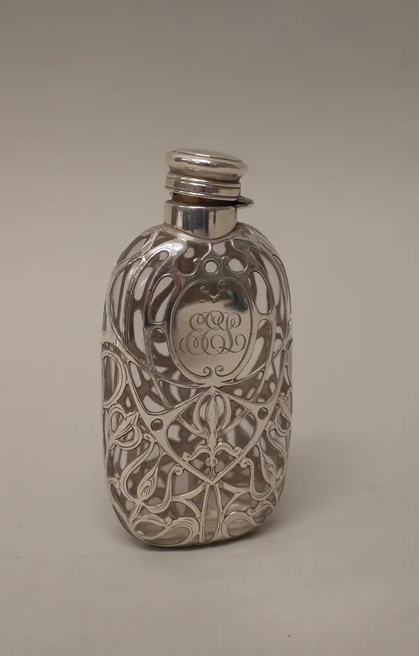An American silver mounted glass spirit flask, with engraved scrolling decoration and monogram engraved.