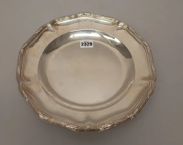 A French main course plate, of shaped circular form, the reeded rim decorated with foliate motifs at intervals, armorial engraved, diameter 30.5cm, we