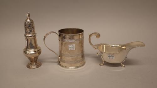 Silver, comprising; an early George III caster of inverted pear shaped form, London 1764, a mug decorated with reeded bands, height 10cm, (the hallmar
