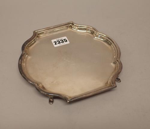 A silver waiter, of shaped form, in the early 18th century taste, raised on four pad feet, length 18.5cm, London 1929, weight 249 gms.