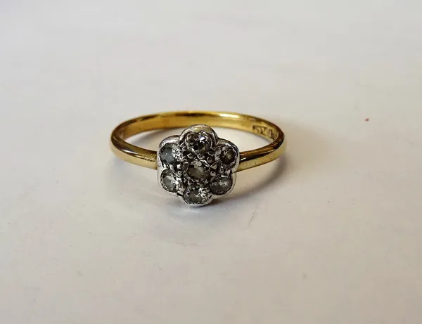 A gold and platinum, diamond set seven stone cluster ring, mounted with circular cut diamonds, detailed 18 CT PLAT, ring size Q.
