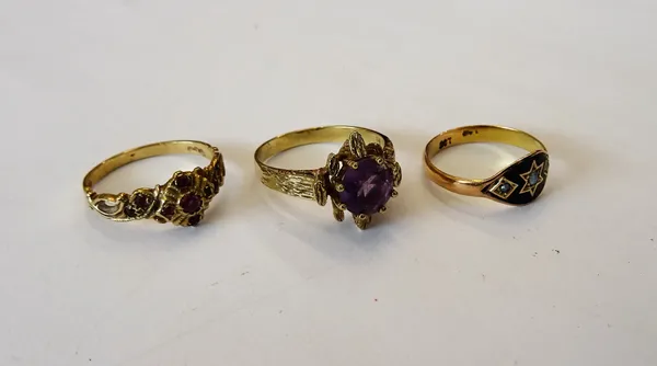 A gold, black enamel and half pearl set mourning ring, detailed 9 CT, a 9ct gold and red gem set cluster ring and a 9ct gold ring, claw set with a cir