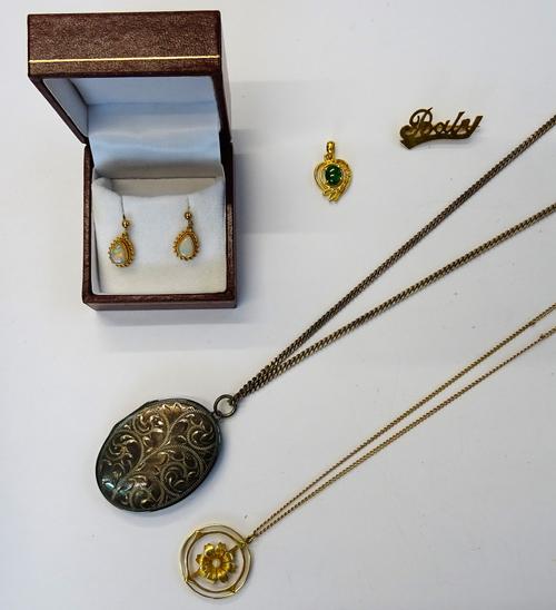 A gold and cultured pearl pendant, designed as a flowerhead, in a circular openwork surround, detailed 15 C, with a gold curb link neckchain, fitted w