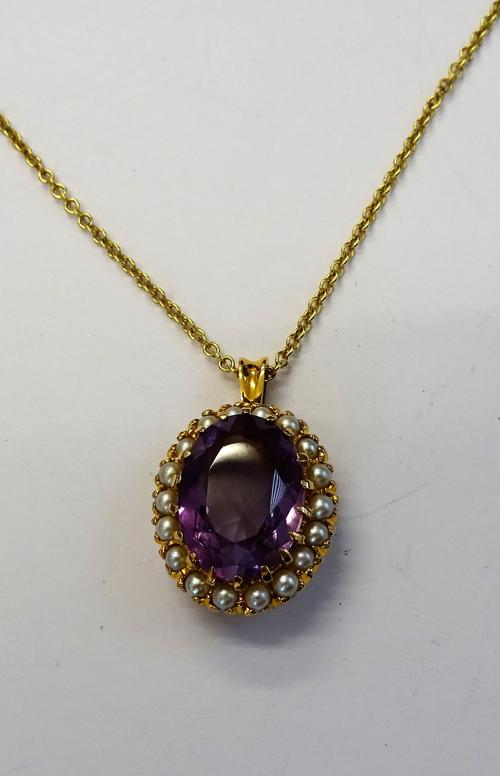 A gold, amethyst and cultured pearl pendant, claw set with the oval cut amethyst within a surround of cultured pearls, with an 18ct gold circular link