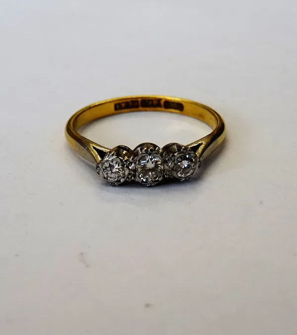 A gold and platinum, diamond set three stone ring, mounted with a row of circular cut diamonds, detailed 18 CT PLAT, ring size M and a half, gross wei