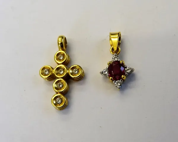 A gold and diamond set pendant, designed as an articulated cross, detailed 750 and a gold, ruby and diamond set pendant, claw set with the oval cut ru