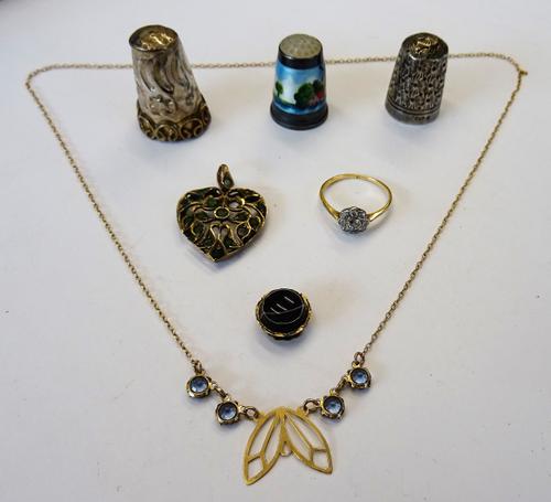 A gold and diamond nine stone cluster ring, mounted with the principal cushion shaped diamond at the centre, in a surround of eight smaller cushion sh