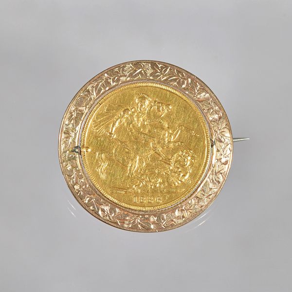 A Victoria young head sovereign, St George and The Dragon reverse, 1886 M, in a gold swiveling mount with foliate engraved decoration, gross weight 10