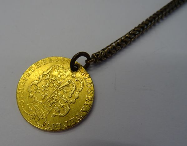 A George III guinea 1785, pierced with a hole, fitted to a Brazil link watch chain, with a swivel, (2).