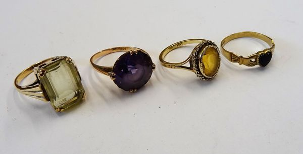 A gold ring, claw set with a cut cornered rectangular step cut, pale green quartz, a gold ring, collet set with an oval cut citrine, a gold ring, claw