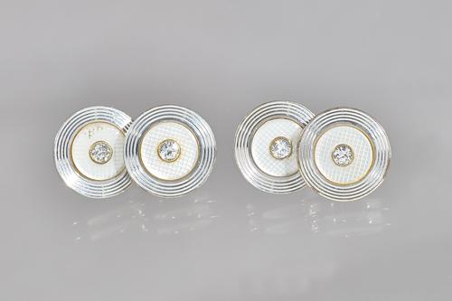 A pair of 9ct white gold, diamond set and mother-of-pearl cufflinks, each back and front of circular form, mounted with a circular cut diamond to the