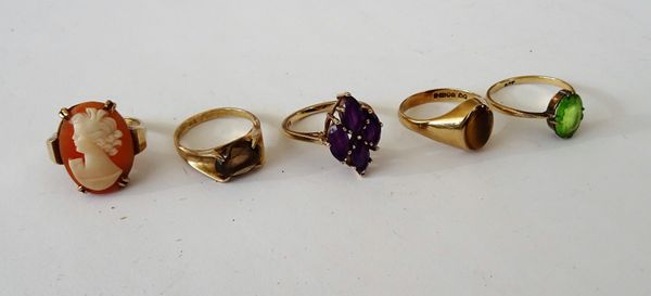 A 9ct gold and oval shell cameo ring, carved as the portrait of a lady, a 9ct gold ring, claw set with four marquise shaped amethysts, a 9ct gold and