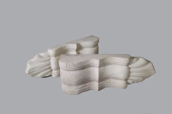 A pair of late Victorian white marble brackets, each of carved moulded form with leaf tip drop, 39cm high, (2).