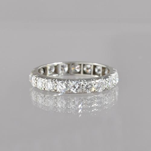 A diamond set full eternity ring, mounted with circular cut diamonds with slight variation of cut, ring size O, gross weight 3.9 gms. Illustrated.