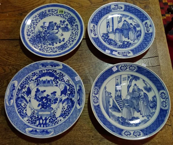 Four Chinese blue and white export plates, early 20th century, two similarly painted with figures outside a house; another painted with two boys holdi