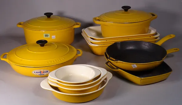 A large quantity of yellow cast iron 'CHASSEUR' cookware.