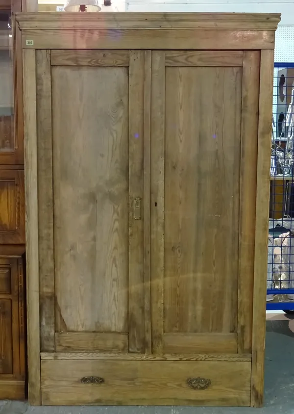 An early 20th century pine double wardrobe with panelled doors and a single drawer to base, 103cm wide x 176cm high.