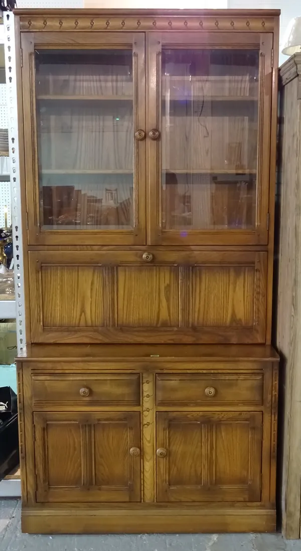 Ercol; an oak two door display cabinet with cupboard base, 98cm wide x 196cm high.